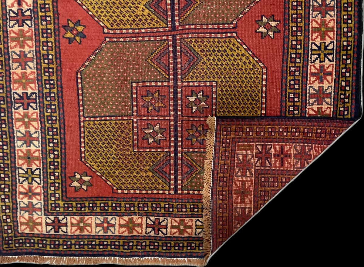 Persian rug of Baluch style in dimensions 187 centimeters length by 110 centimeters width with mainly red colors — Folded