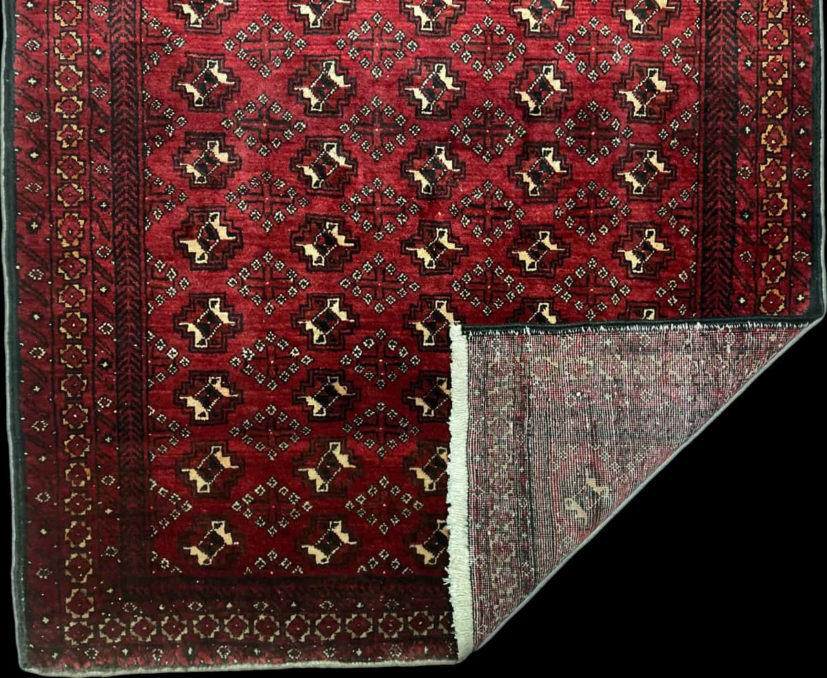 Persian rug of Baluch style in dimensions 218 centimeters length by 106 centimeters width with mainly red colors — Folded