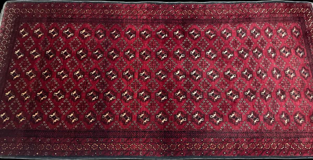 Persian rug of Baluch style in dimensions 218 centimeters length by 106 centimeters width with mainly red colors — Perspective