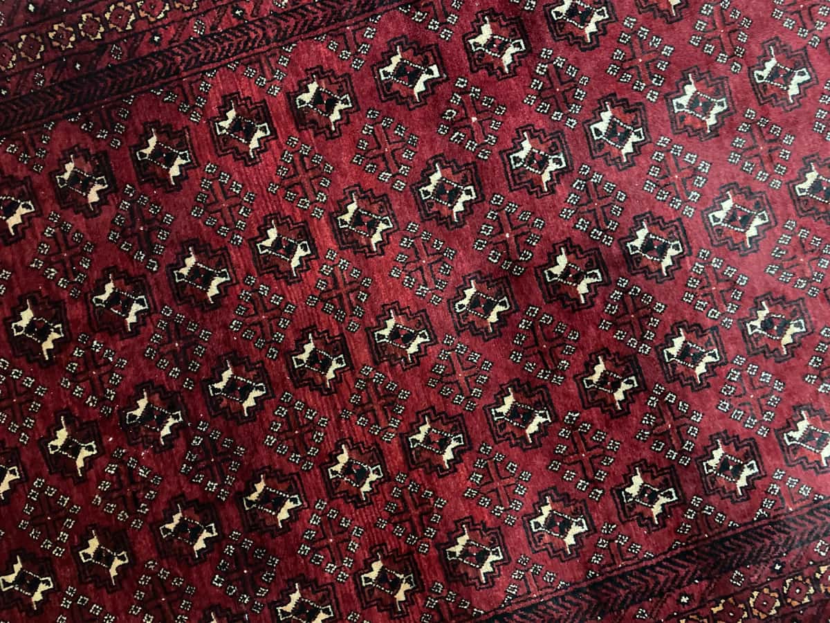Persian rug of Baluch style in dimensions 218 centimeters length by 106 centimeters width with mainly red colors — Perspective