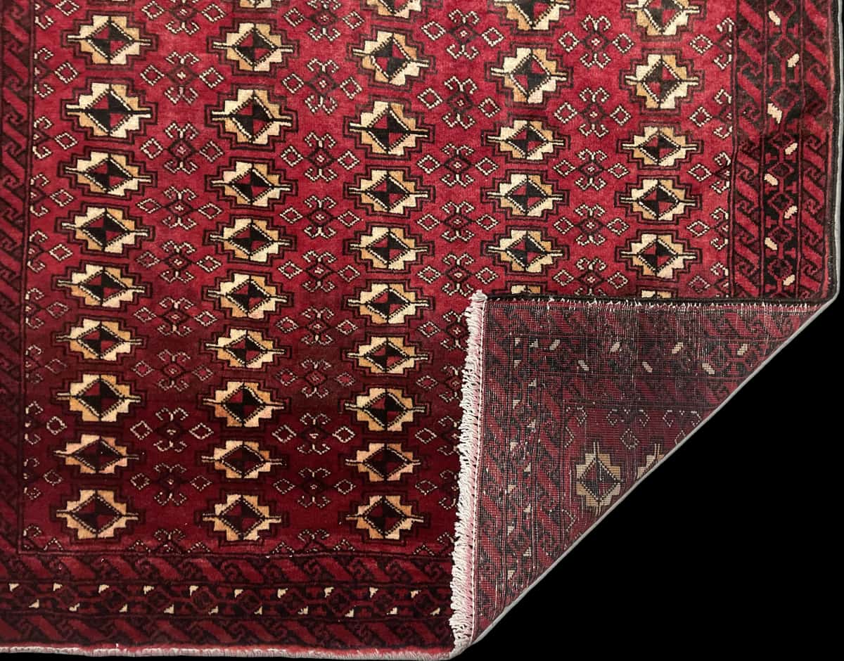 Persian rug of Baluch style in dimensions 204 centimeters length by 116 centimeters width with mainly red colors — Folded