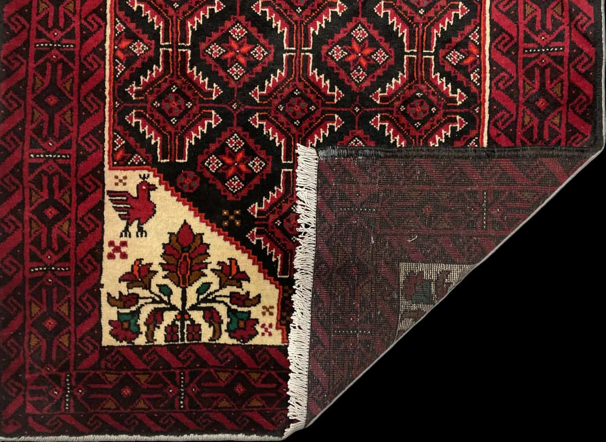 Persian rug of Baluch style in dimensions 194 centimeters length by 105 centimeters width with mainly red colors — Folded