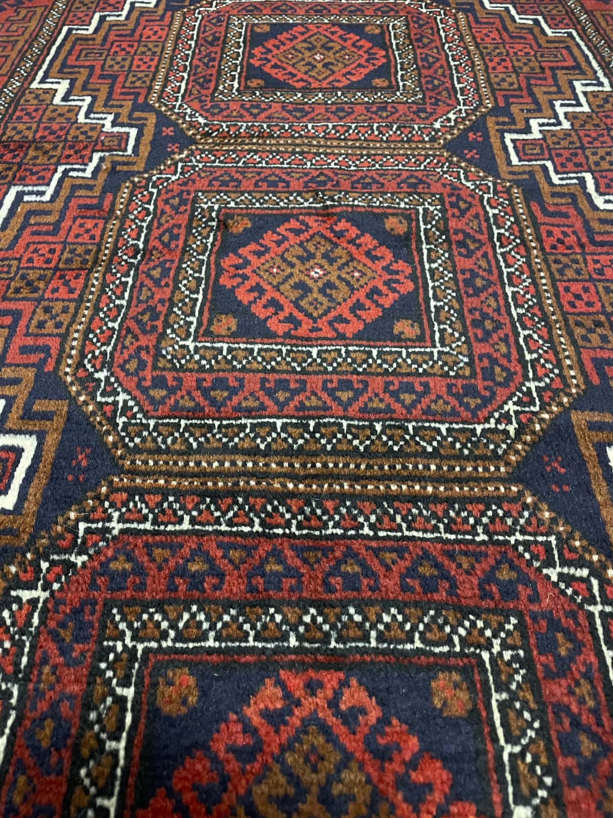 Persian rug of Turkoman style in dimensions 162 centimeters length by 87 centimeters width with mainly red colors — Texture close-up