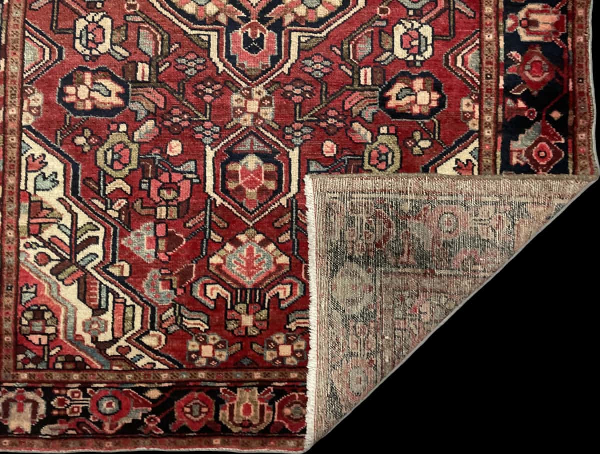 Persian rug of Bakhtiari style in dimensions 202 centimeters length by 123 centimeters width with mainly red colors — Folded