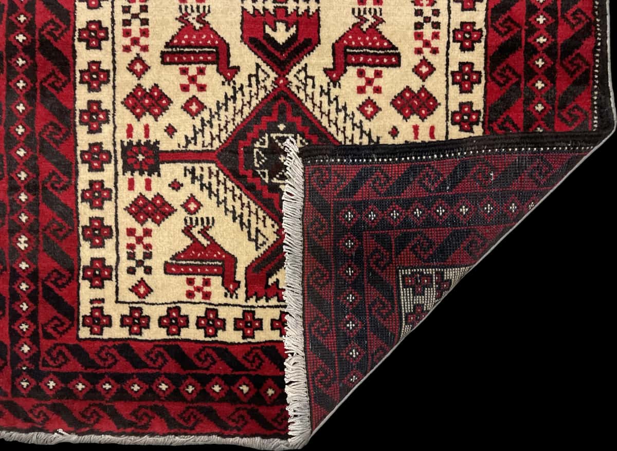 Persian rug of Baluch style in dimensions 187 centimeters length by 106 centimeters width with mainly beige and red colors — Folded