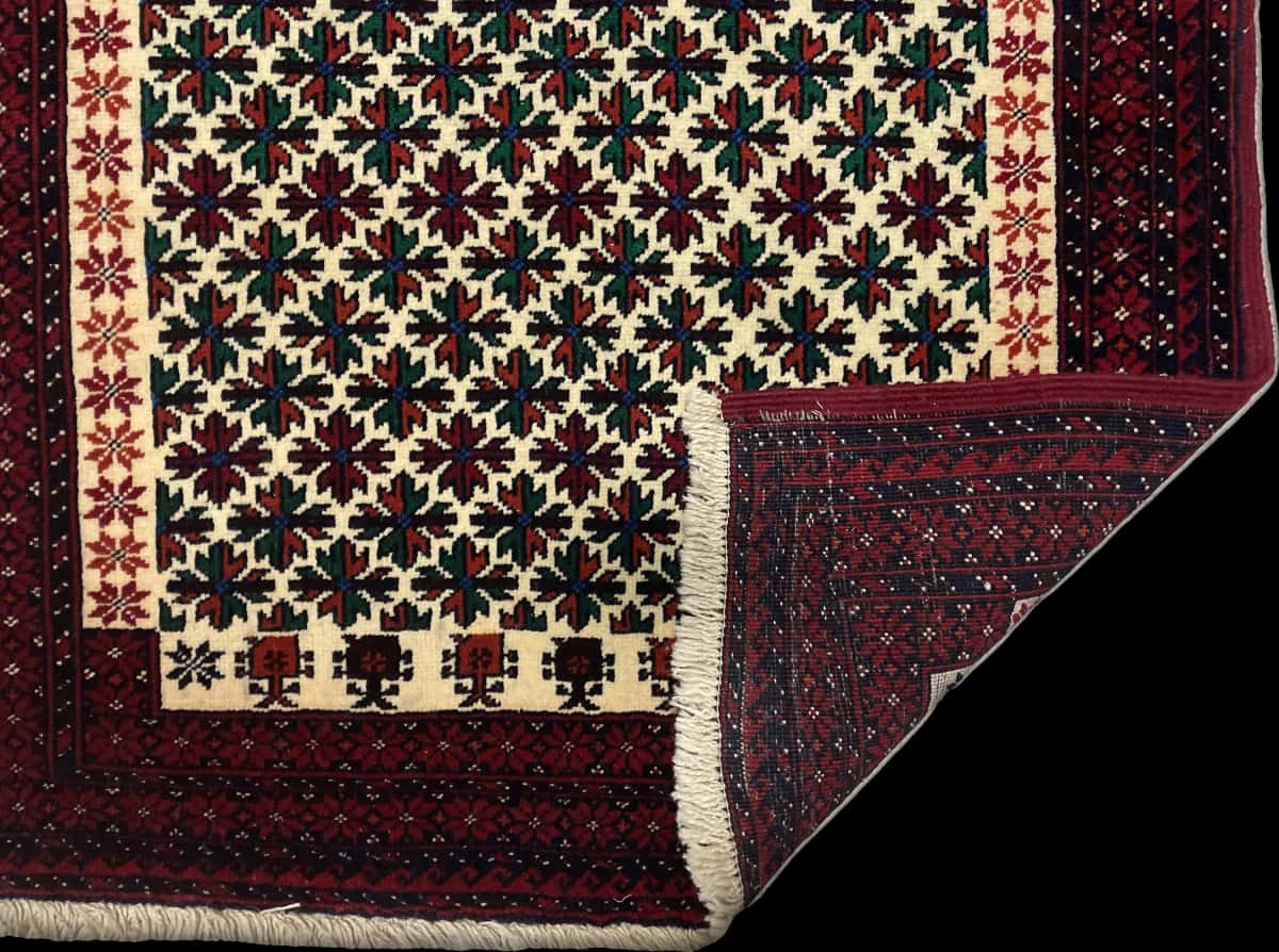 Persian rug of Baluch style in dimensions 182 centimeters length by 100 centimeters width with mainly red colors — Folded