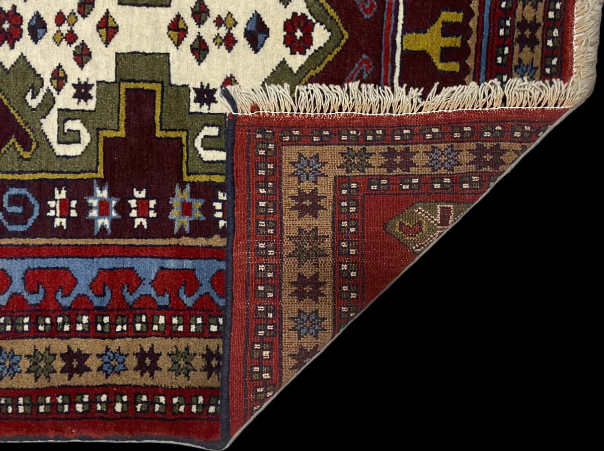 Persian rug of Quchan style in dimensions 172 centimeters length by 117 centimeters width with mainly red and green colors — Folded