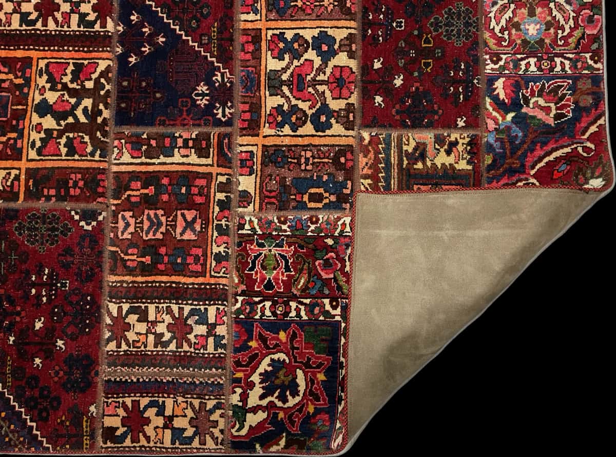 Persian rug of Patchwork style in dimensions 210 centimeters length by 137 centimeters width with mainly red colors — Folded