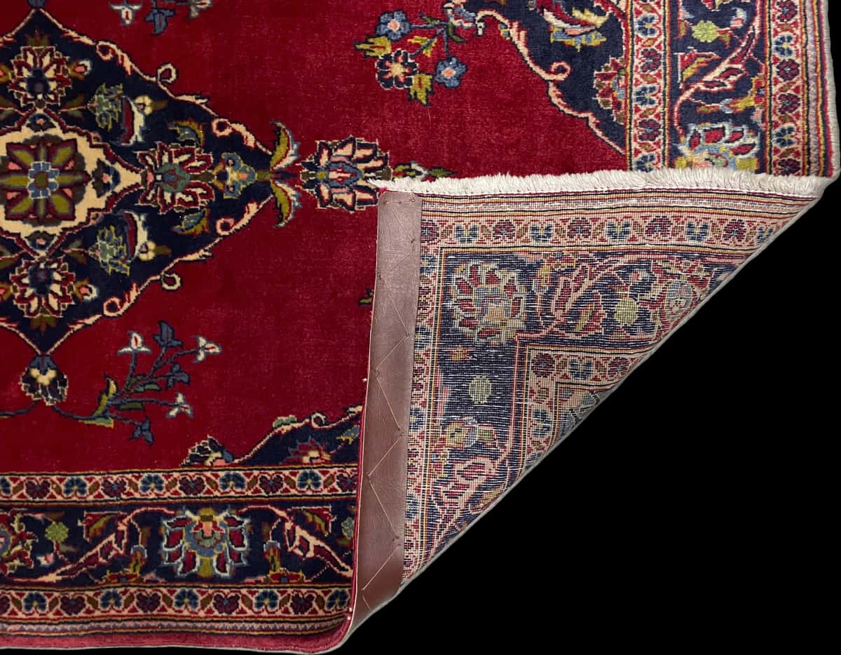 Persian rug of Kashan style in dimensions 137 centimeters length by 83 centimeters width with mainly red colors — Folded