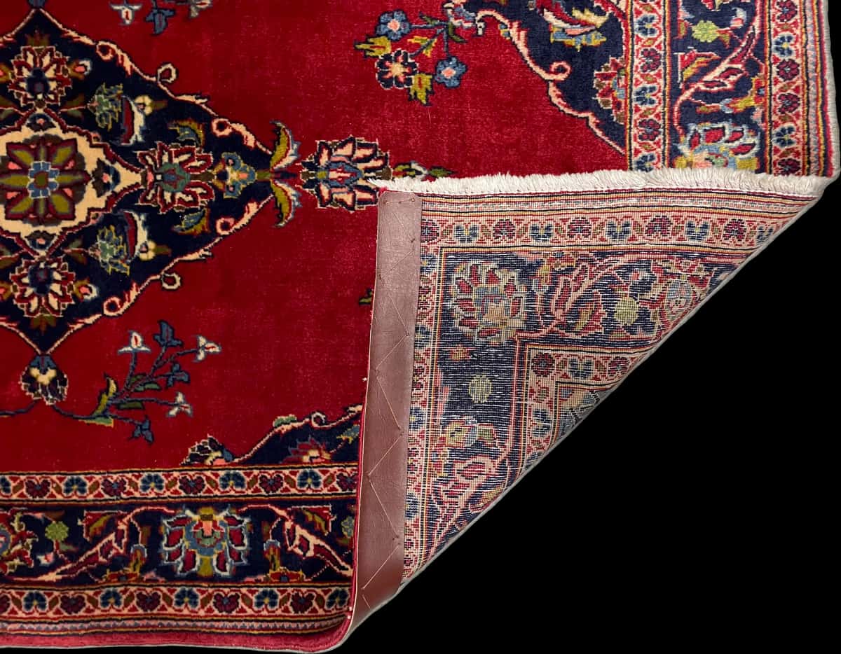 Persian rug of Kashan style in dimensions 137 centimeters length by 83 centimeters width with mainly red colors — Folded