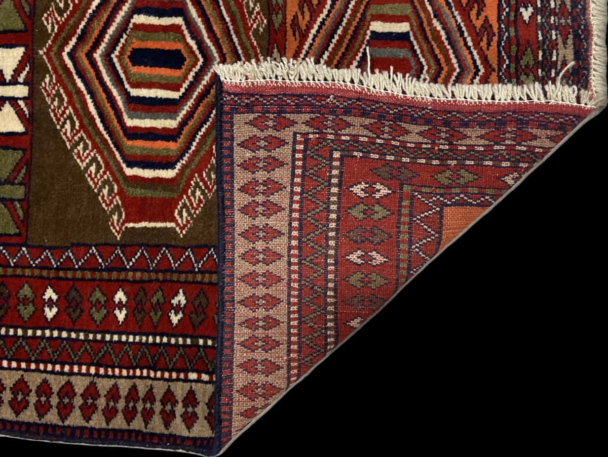 Persian rug of Quchan style in dimensions 175 centimeters length by 105 centimeters width with mainly red and orange colors — Folded