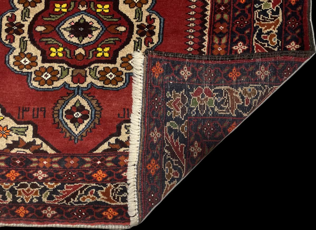 Persian rug of Baluch style in dimensions 198 centimeters length by 111 centimeters width with mainly red and orange colors — Folded
