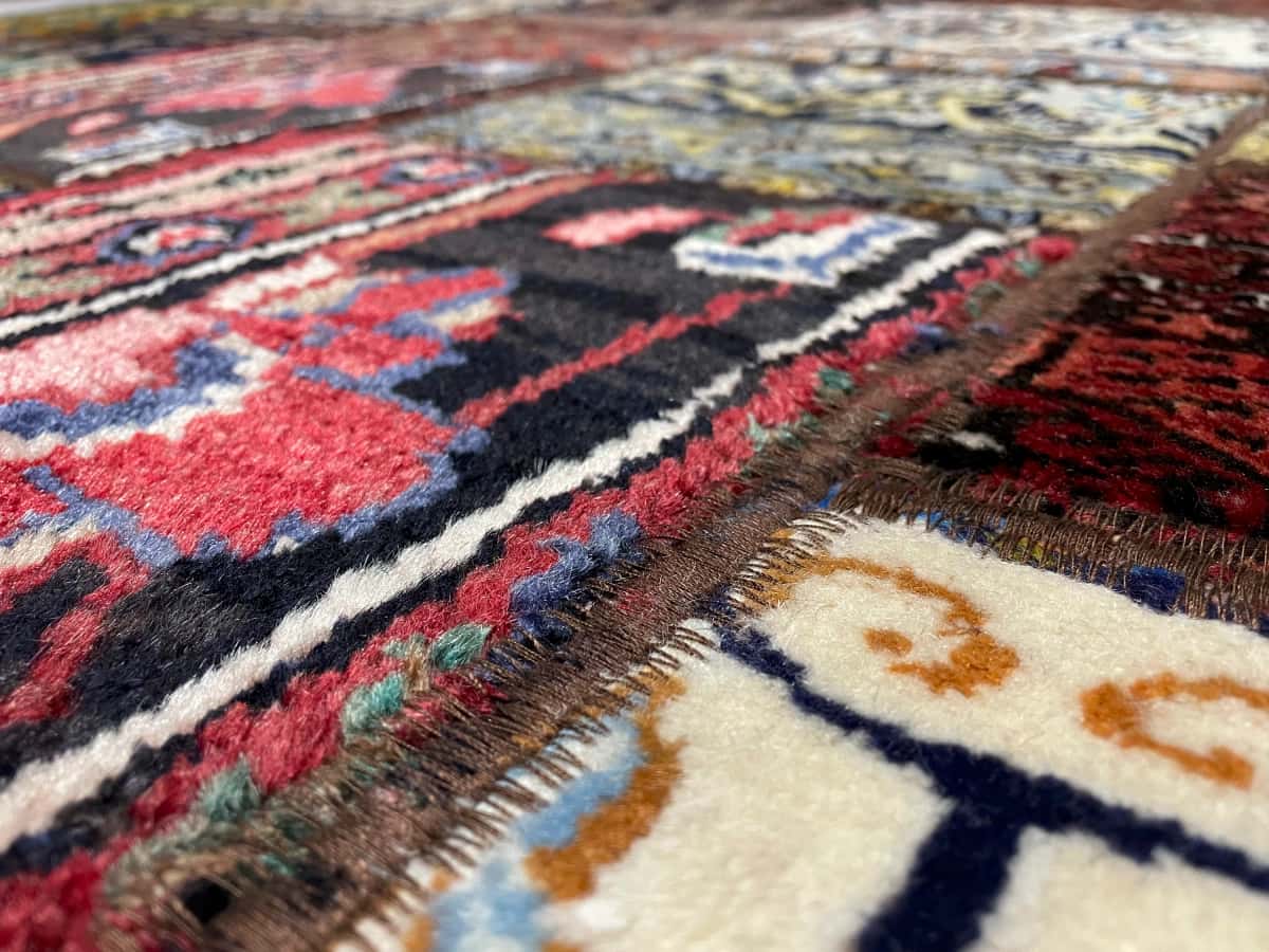 Persian rug of Patchwork style in dimensions 202 centimeters length by 150 centimeters width with mainly red and colorful colors — Texture close-up