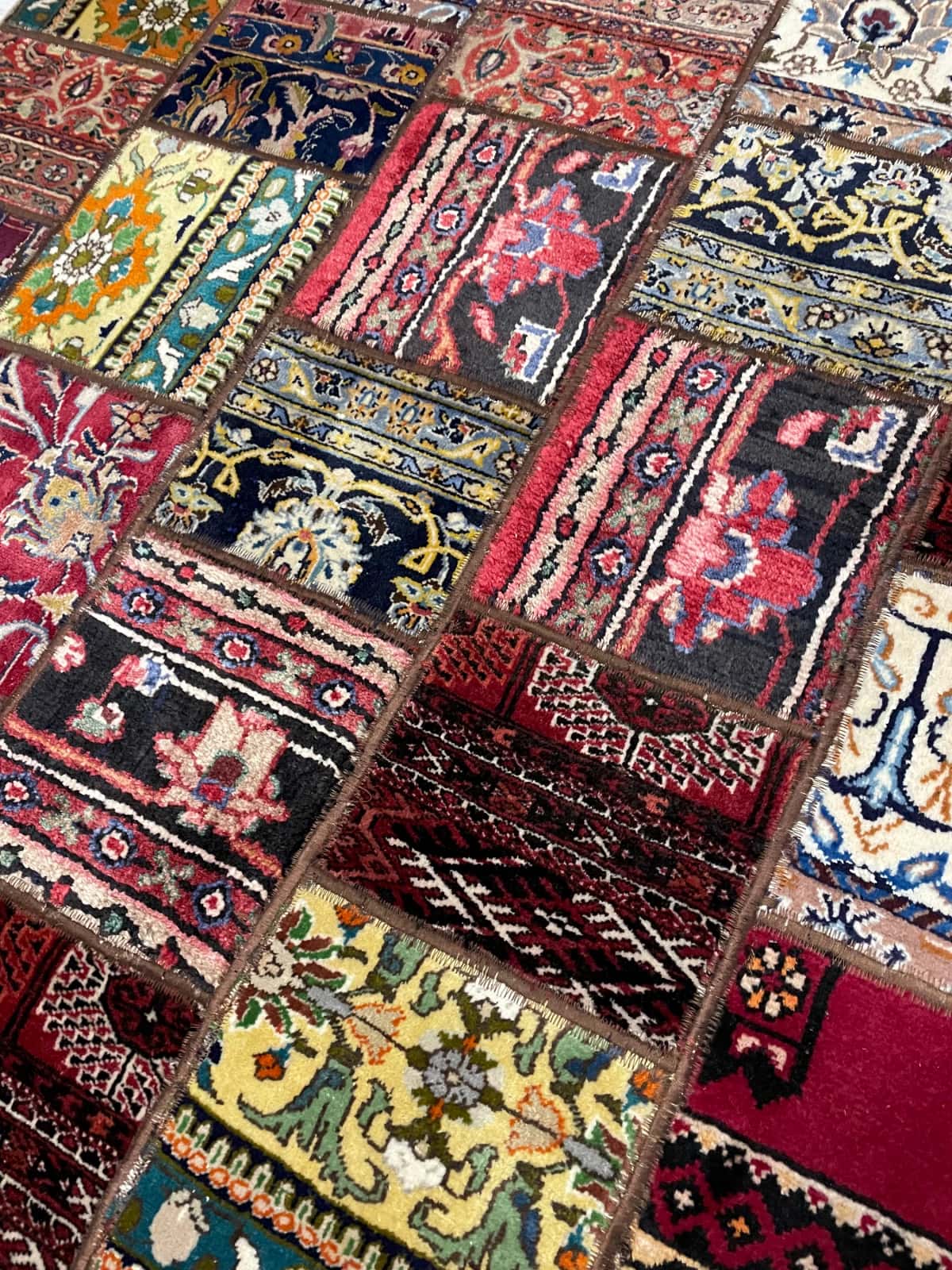 Persian rug of Patchwork style in dimensions 202 centimeters length by 150 centimeters width with mainly red and colorful colors — Texture close-up