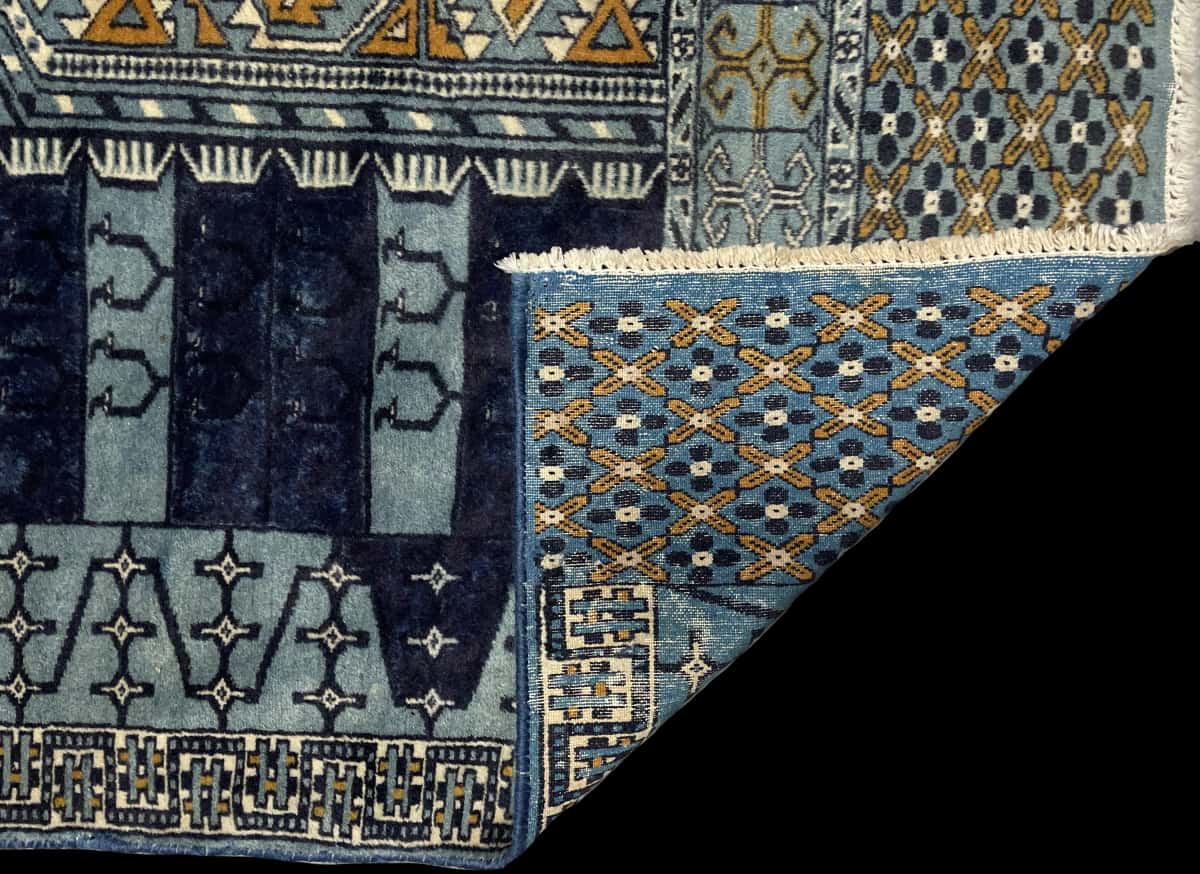 Persian rug of Turkoman style in dimensions 166 centimeters length by 95 centimeters width with mainly blue colors — Folded