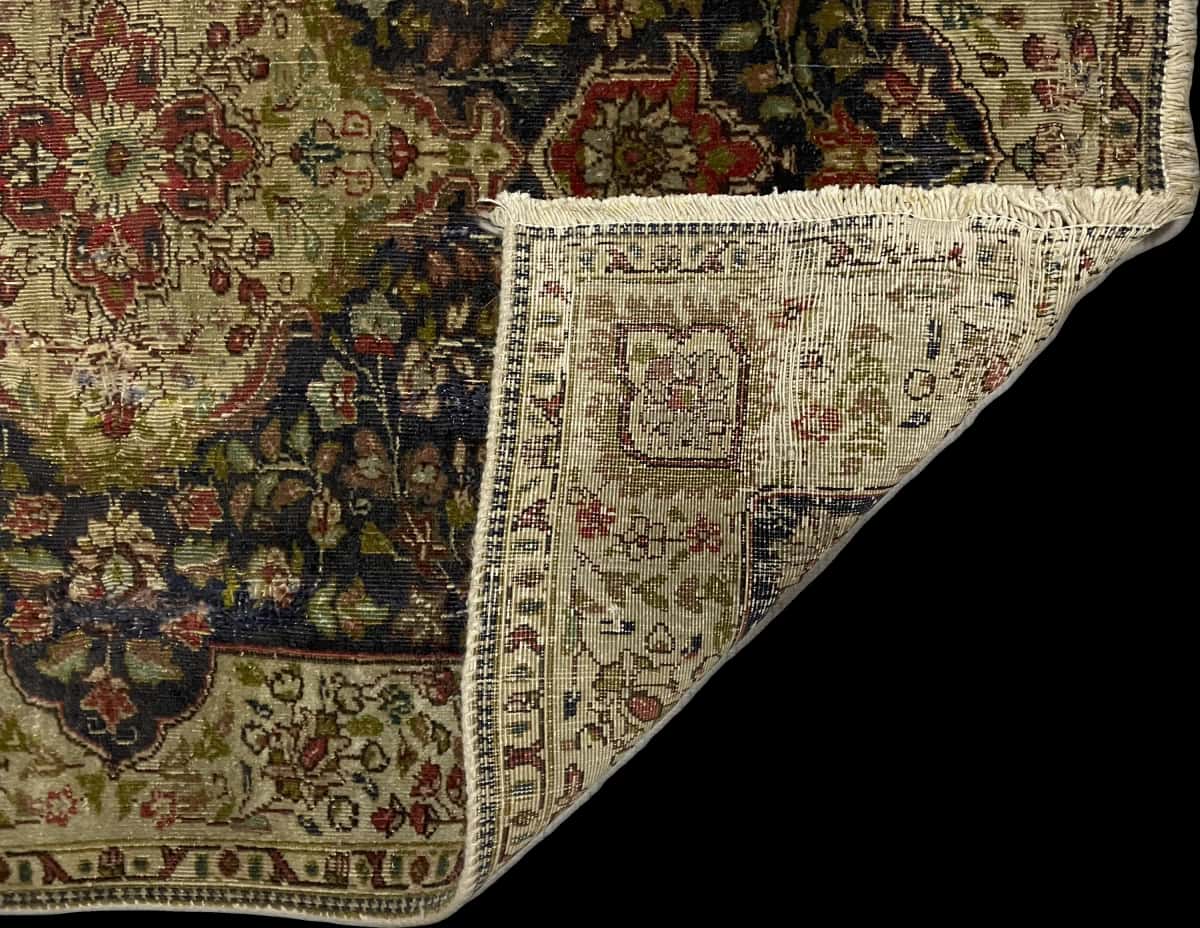 Persian rug of Tabriz style in dimensions 153 centimeters length by 110 centimeters width with mainly green and blue colors — Folded