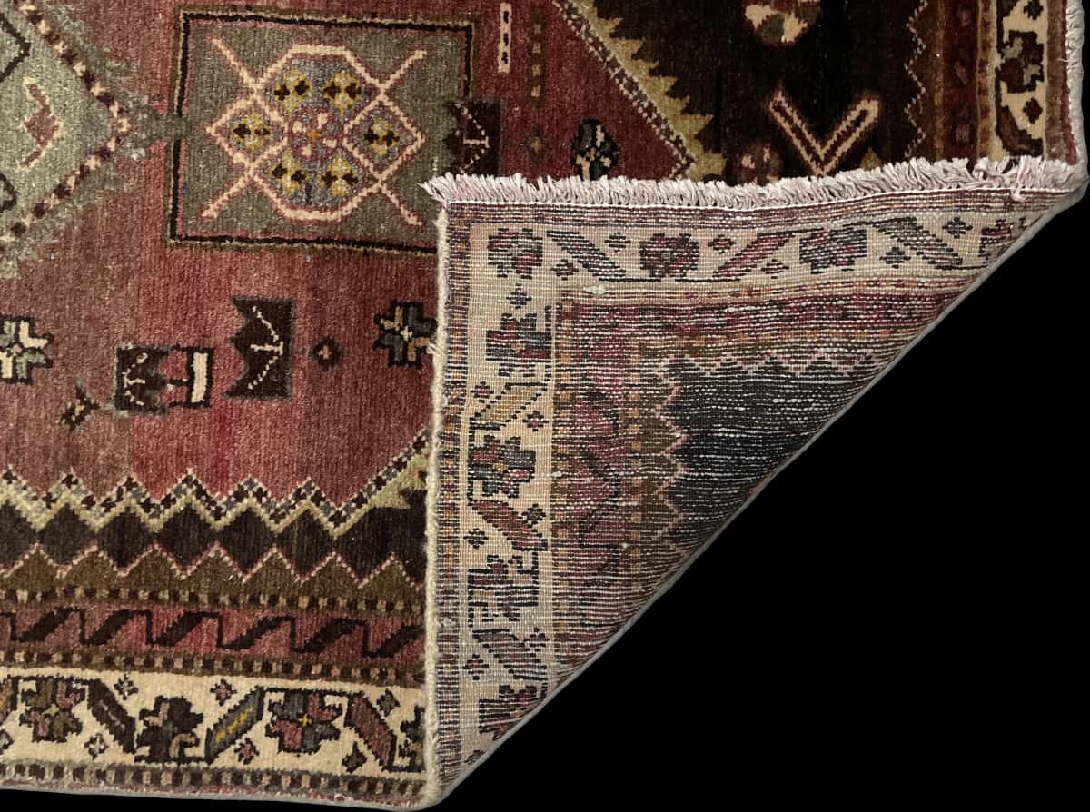 Persian rug of Zanjan style in dimensions 215 centimeters length by 100 centimeters width with mainly green and brown colors — Folded