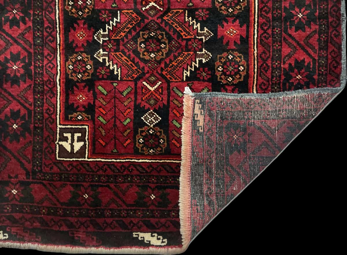 Persian rug of Baluch style in dimensions 212 centimeters length by 110 centimeters width with mainly red colors — Folded