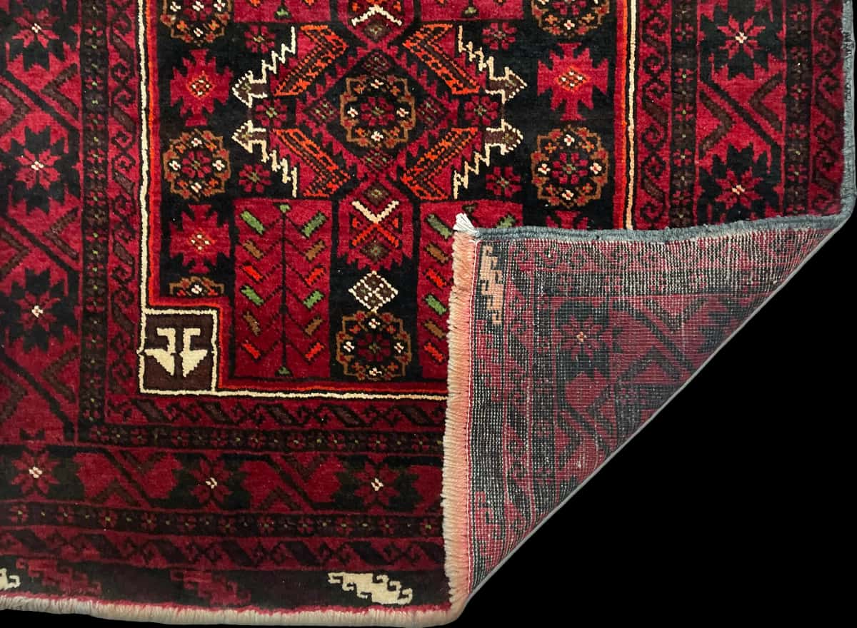 Persian rug of Baluch style in dimensions 212 centimeters length by 110 centimeters width with mainly red colors — Folded