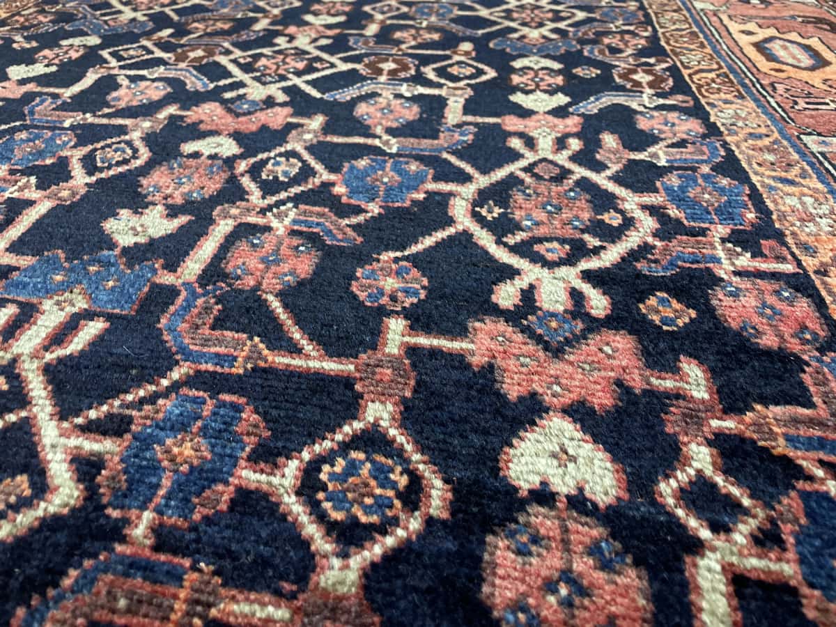 Persian rug of Borujerd style in dimensions 244 centimeters length by 130 centimeters width with mainly blue and brown colors — Texture close-up