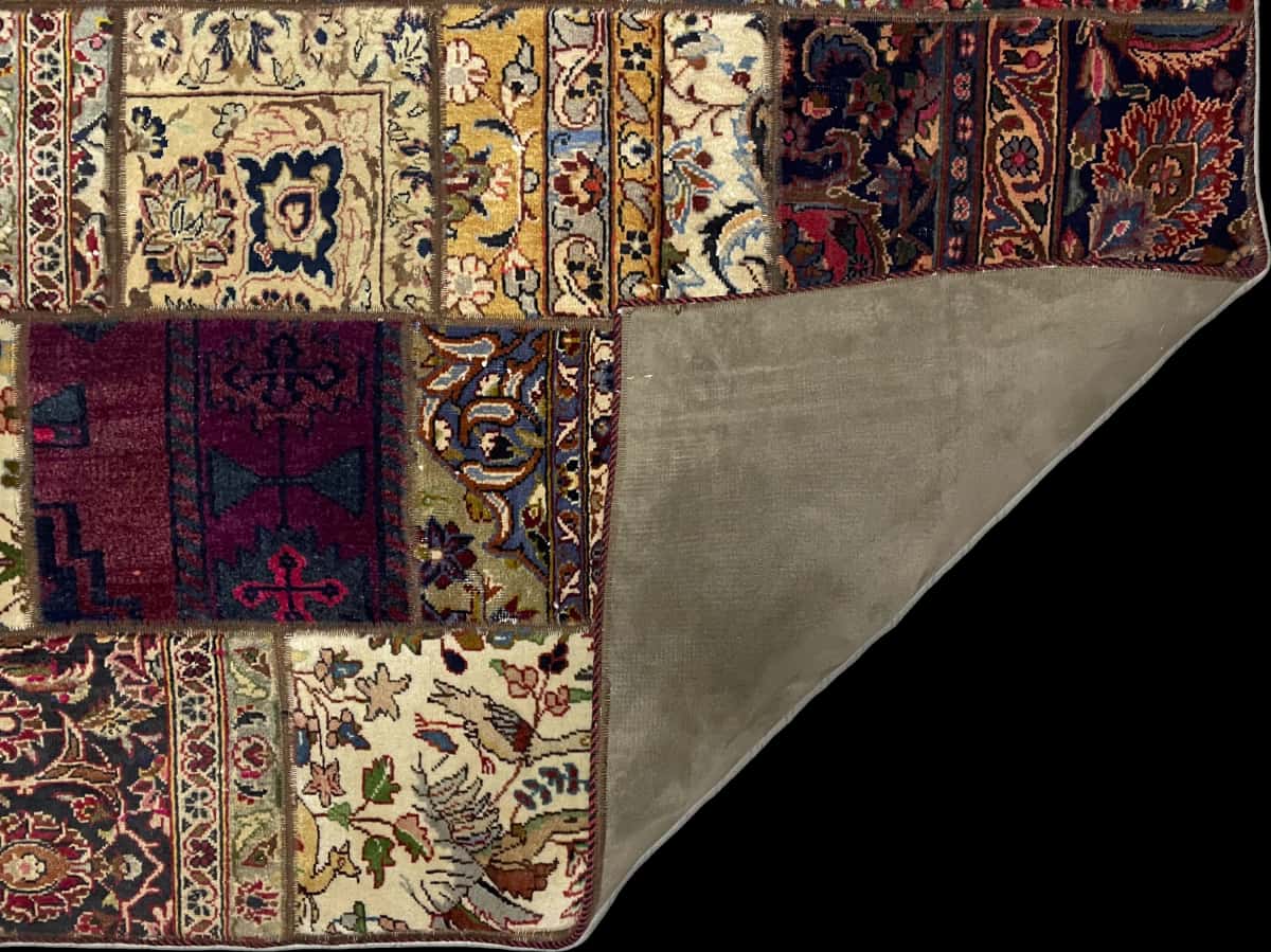 alfombra persa de estilo patchwork en dimensiones 207 centímetros de largo por 151 centímetros de ancho con colores principalmente rojo y amarillo — Plegada