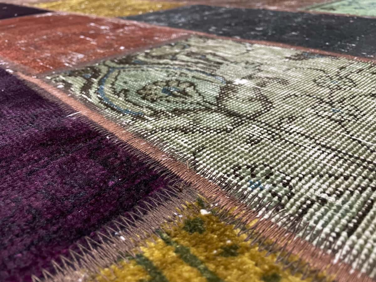 Persian rug of Patchwork style in dimensions 200 centimeters length by 153 centimeters width with mainly colorful colors — Texture close-up