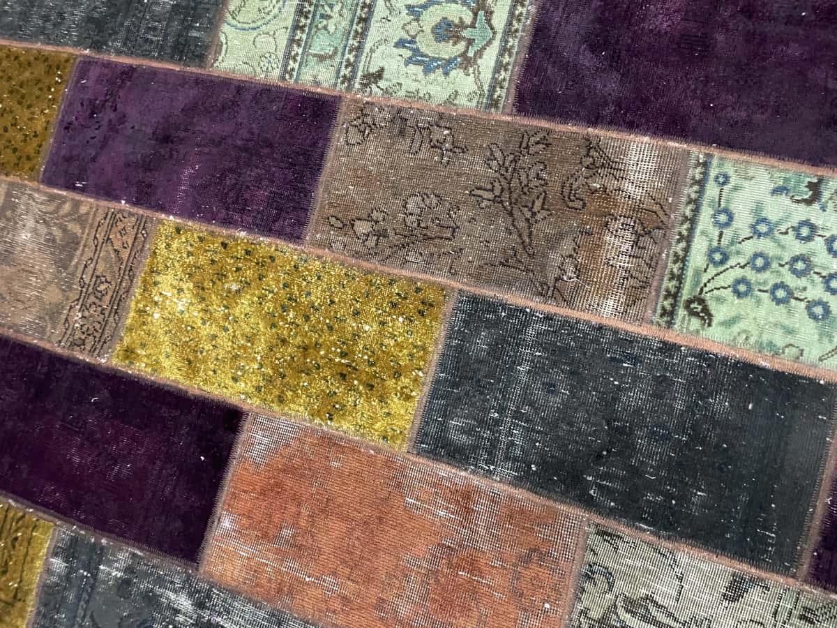 Persian rug of Patchwork style in dimensions 200 centimeters length by 153 centimeters width with mainly colorful colors — Texture close-up