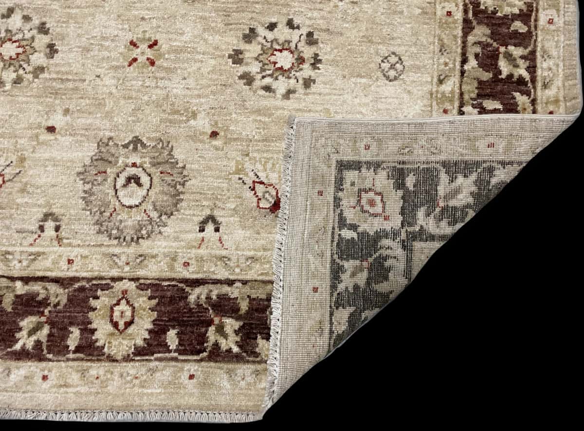 Pakistan rug in dimensions 205 centimeters length by 144 centimeters width with mainly yellow and brown colors — Folded