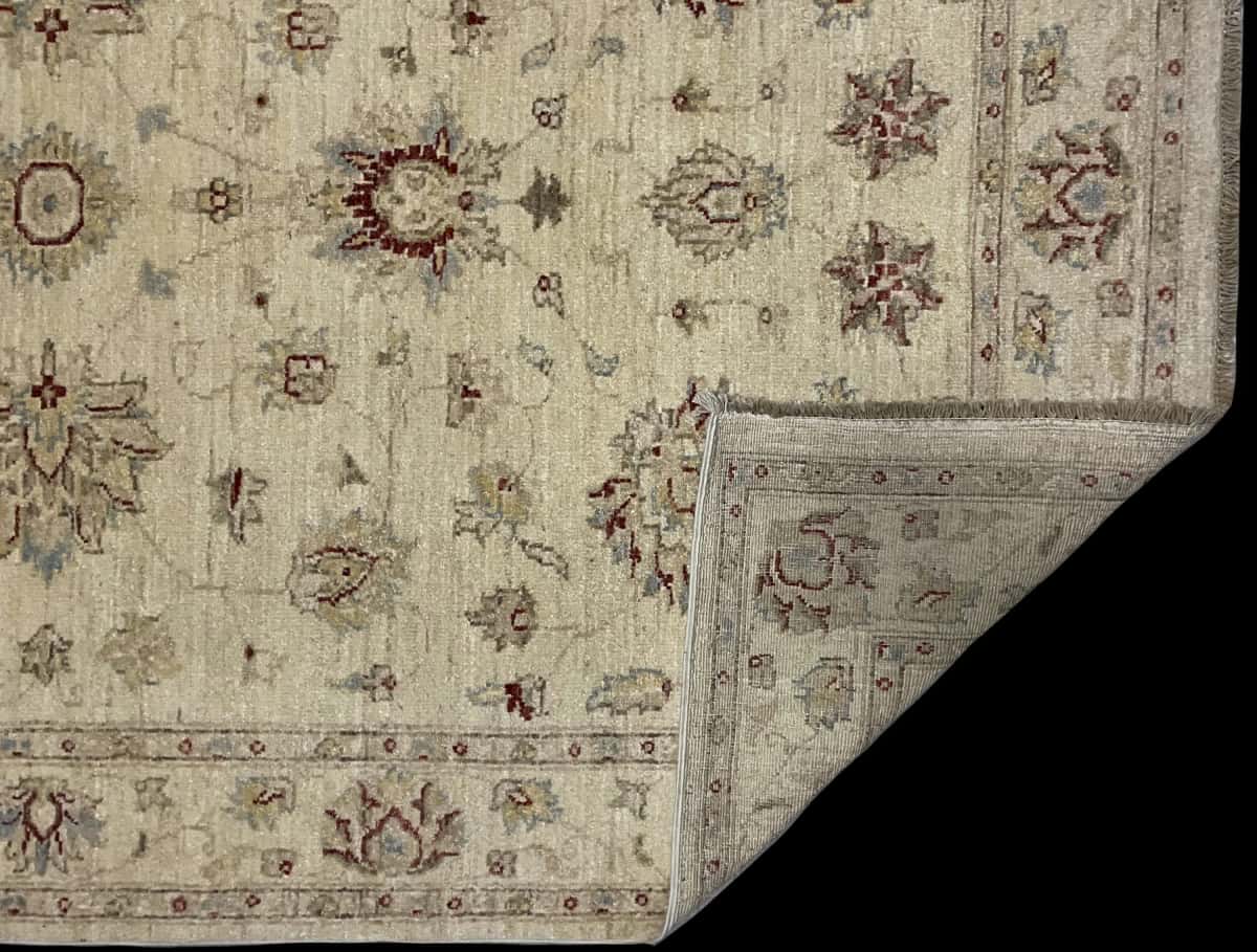 Pakistan rug in dimensions 216 centimeters length by 137 centimeters width with mainly yellow colors — Folded