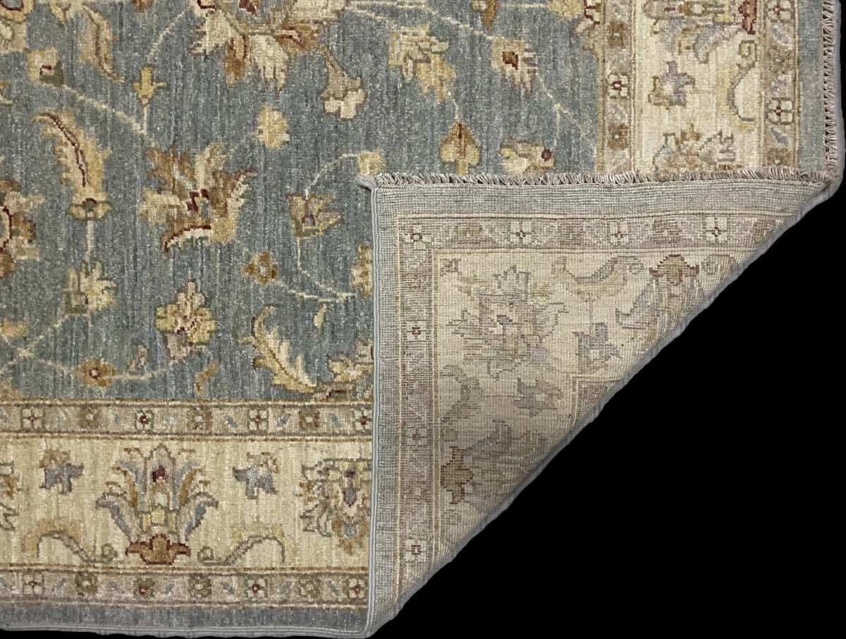 Pakistan rug in dimensions 201 centimeters length by 144 centimeters width with mainly blue and yellow colors — Folded