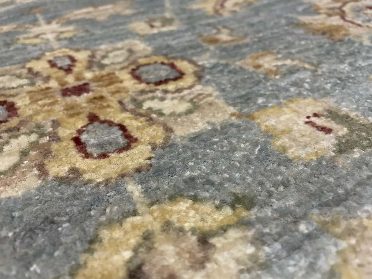 Pakistan rug in dimensions 201 centimeters length by 144 centimeters width with mainly blue and yellow colors — Texture close-up