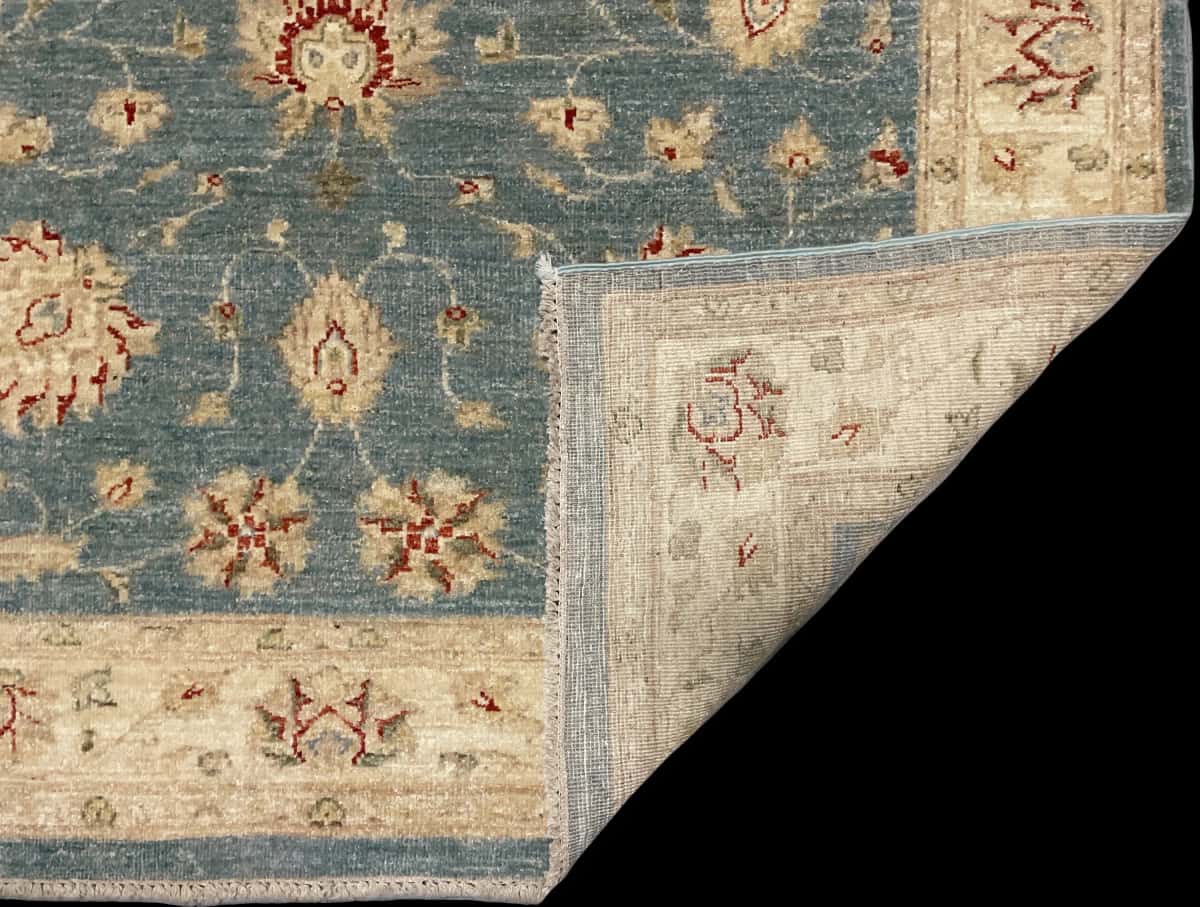 Pakistan rug in dimensions 200 centimeters length by 139 centimeters width with mainly blue and yellow colors — Folded