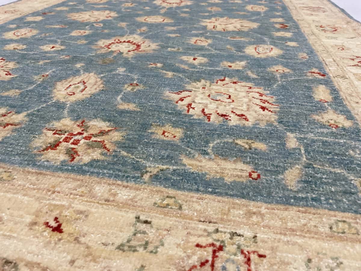 Pakistan rug in dimensions 200 centimeters length by 139 centimeters width with mainly blue and yellow colors — Texture close-up