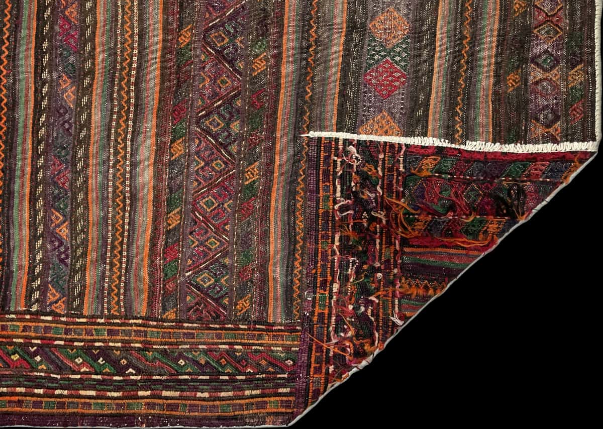 Persian rug of Sumak style in dimensions 156 centimeters length by 113 centimeters width with mainly purple and brown colors — Folded