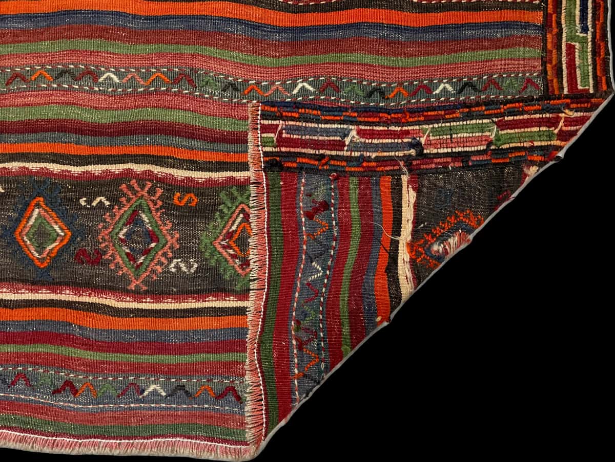 Persian rug of Sumak style in dimensions 196 centimeters length by 156 centimeters width with mainly brown and red colors — Folded