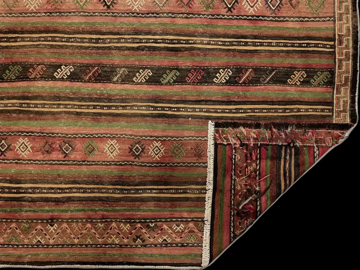 Persian rug of Sumak style in dimensions 200 centimeters length by 150 centimeters width with mainly red and green colors — Folded