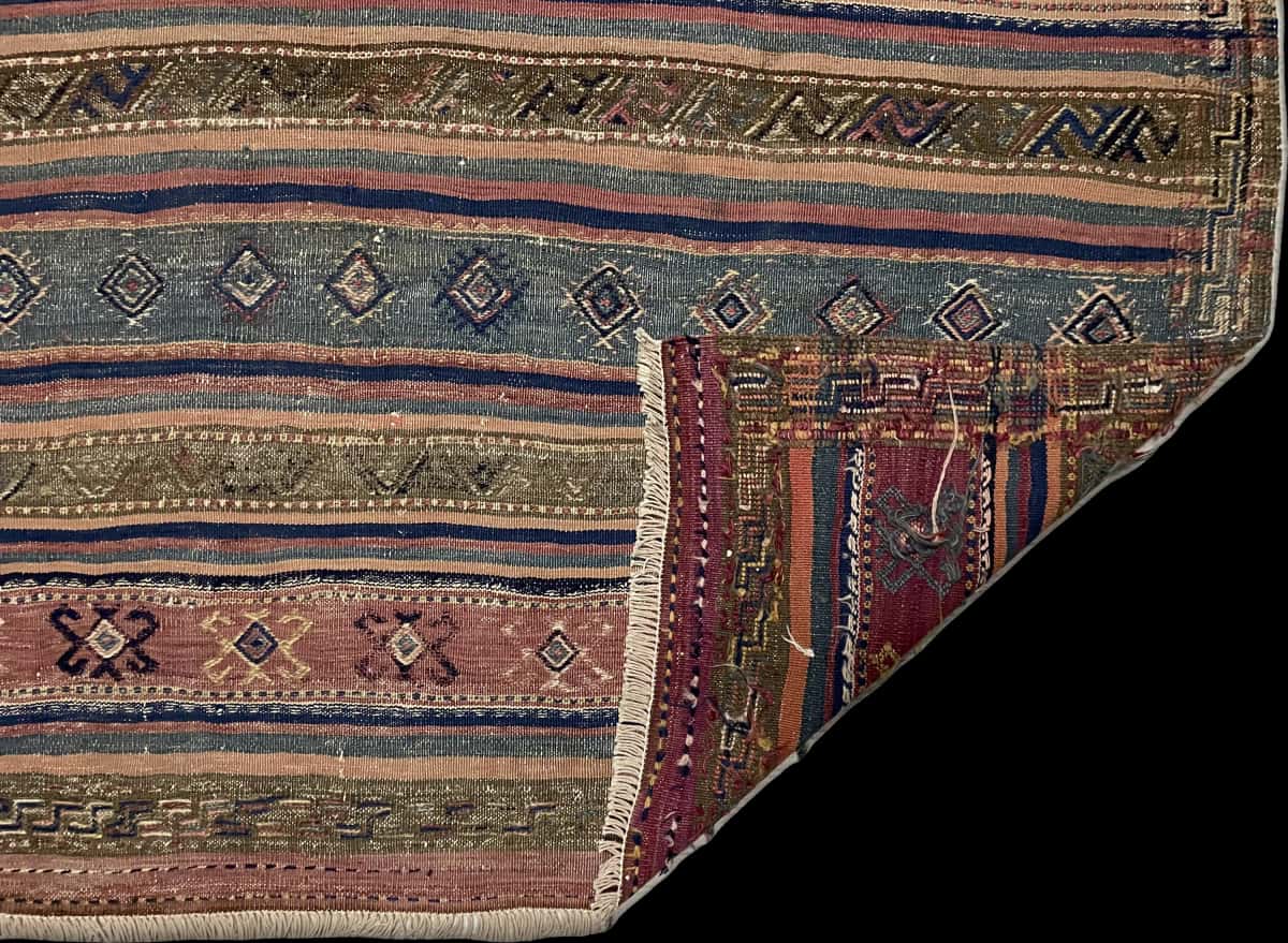 Persian rug of Sumak style in dimensions 245 centimeters length by 177 centimeters width with mainly blue and brown colors — Folded