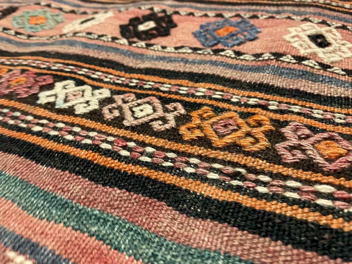 Persian rug of Sumak style in dimensions 273 centimeters length by 140 centimeters width with mainly brown colors — Texture close-up