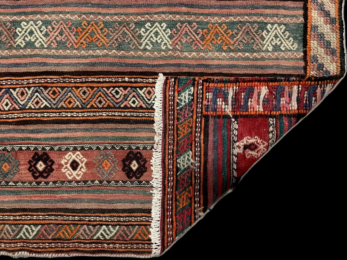 Persian rug of Sumak style in dimensions 273 centimeters length by 140 centimeters width with mainly brown colors — Folded