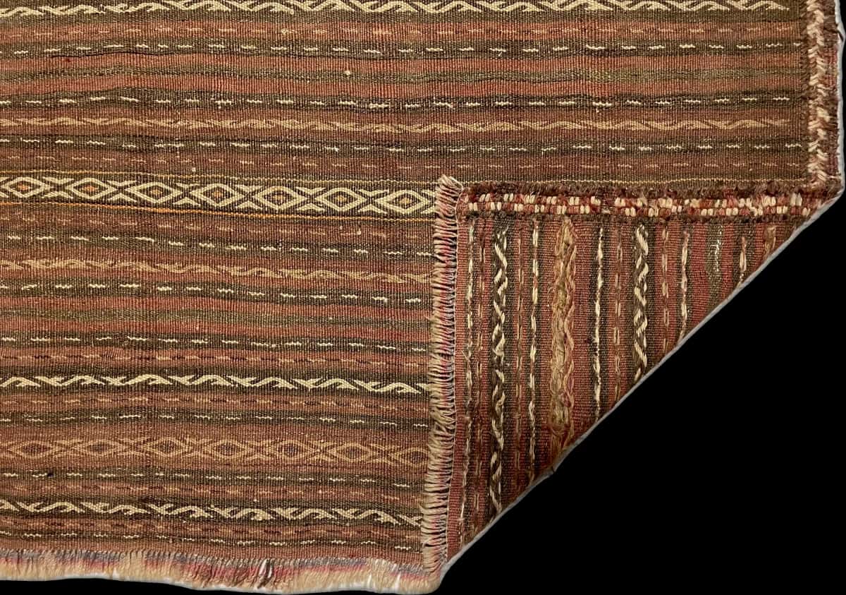 Persian rug of Sumak style in dimensions 290 centimeters length by 153 centimeters width with mainly red and brown colors — Folded