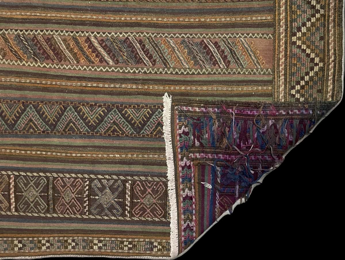 Persian rug of Sumak style in dimensions 206 centimeters length by 141 centimeters width with mainly green and purple colors — Folded