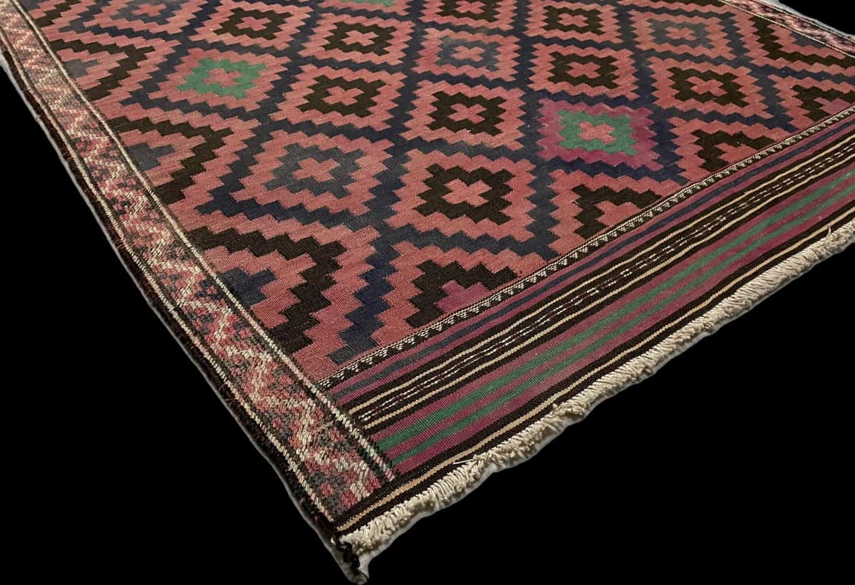 alfombra persa de estilo sumak en dimensiones 270 centímetros de largo por 135 centímetros de ancho con colores principalmente rojo y negro — Esquina y borde