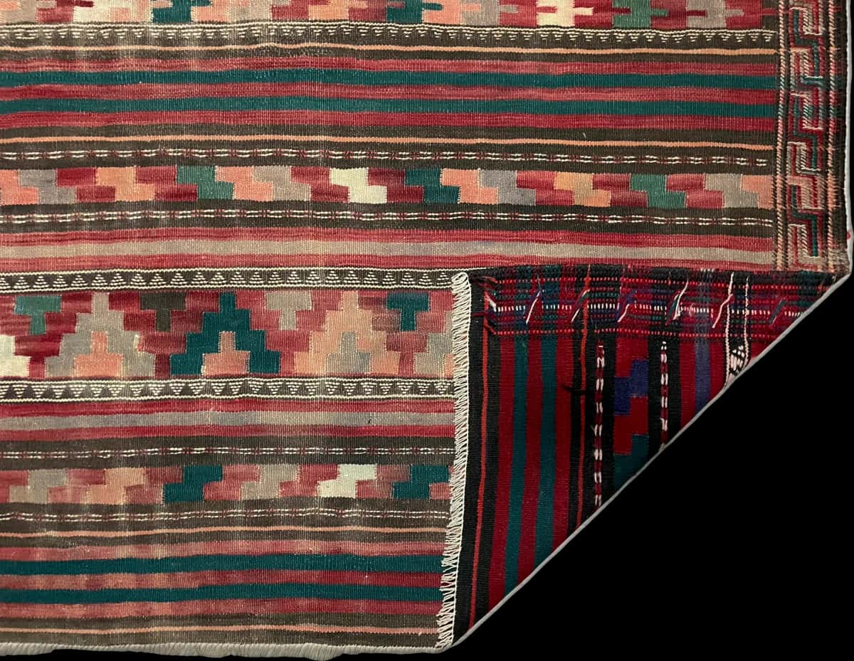 Persian rug of Sumak style in dimensions 268 centimeters length by 130 centimeters width with mainly red colors — Folded