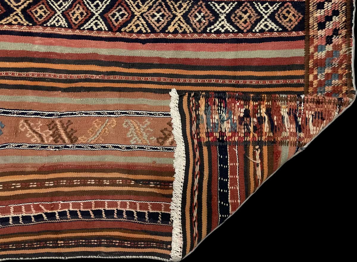 Persian rug of Sumak style in dimensions 128 centimeters length by 113 centimeters width with mainly brown and red colors — Folded