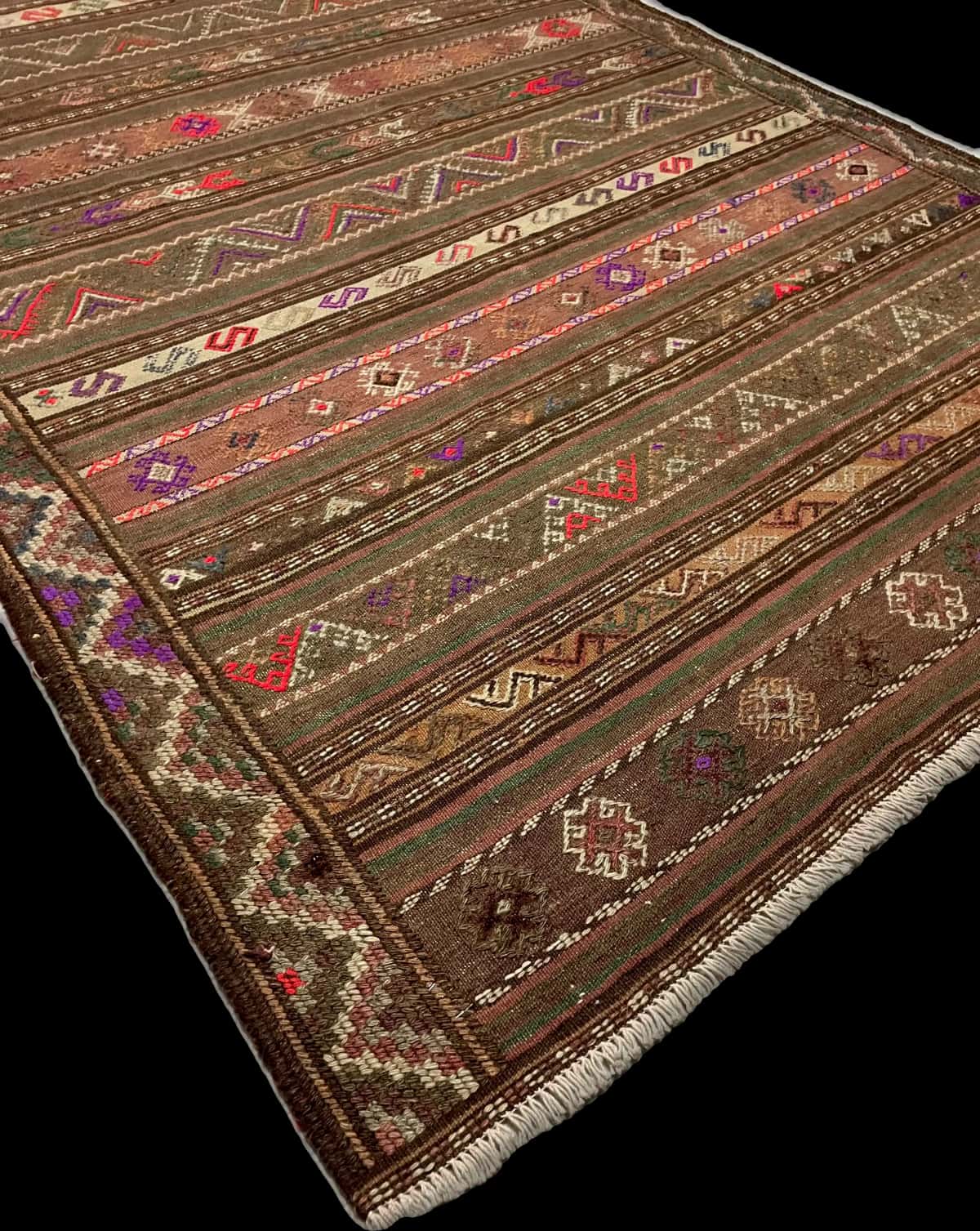 Persian rug of Sumak style in dimensions 260 centimeters length by 145 centimeters width with mainly brown and green colors — Corner & edge