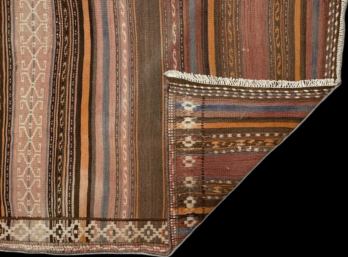 Persian rug of Sumak style in dimensions 180 centimeters length by 145 centimeters width with mainly orange colors — Folded