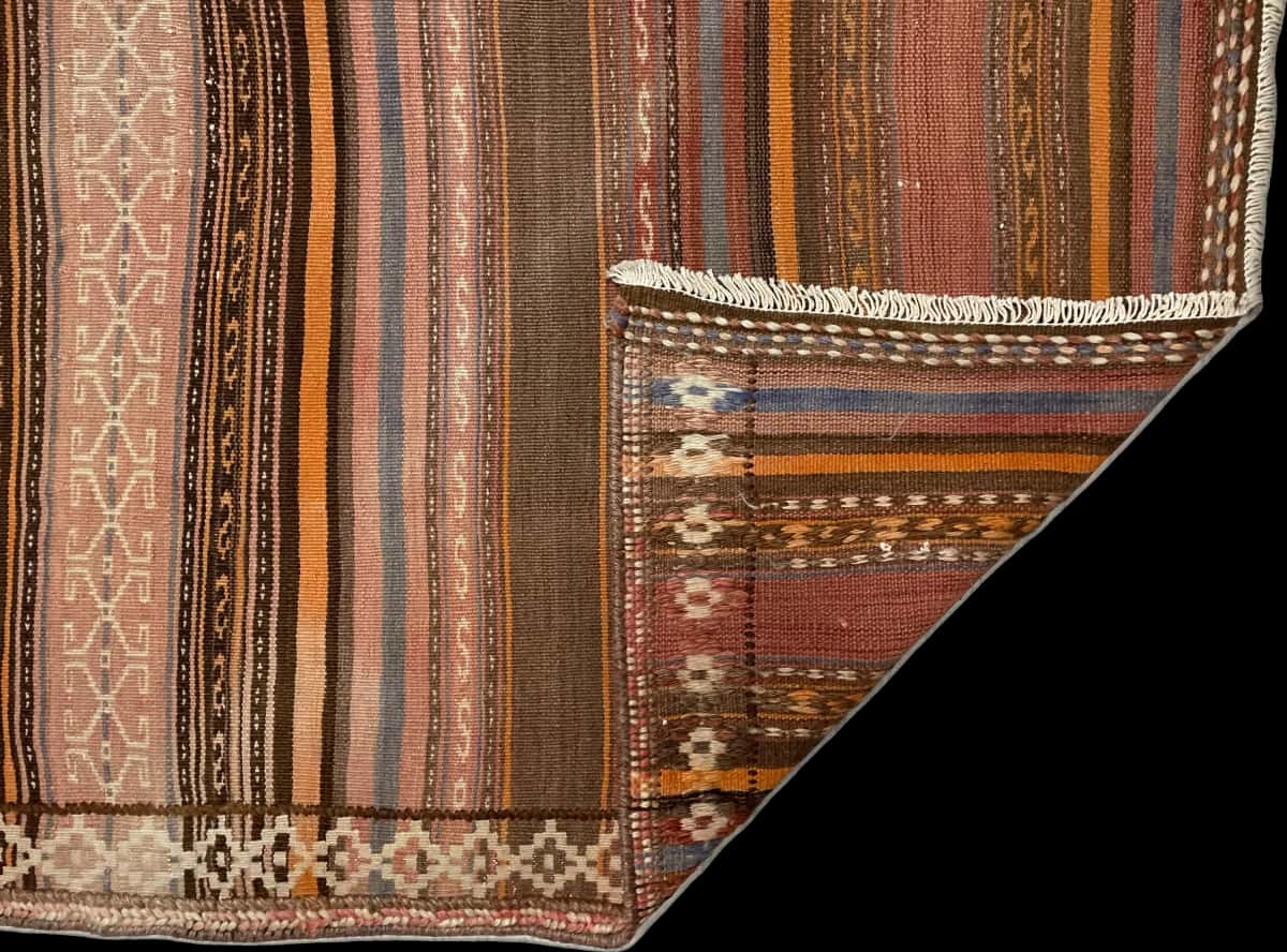 Persian rug of Sumak style in dimensions 180 centimeters length by 145 centimeters width with mainly orange colors — Folded
