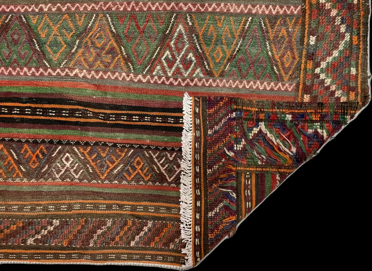 Persian rug of Sumak style in dimensions 155 centimeters length by 135 centimeters width with mainly green and brown colors — Folded