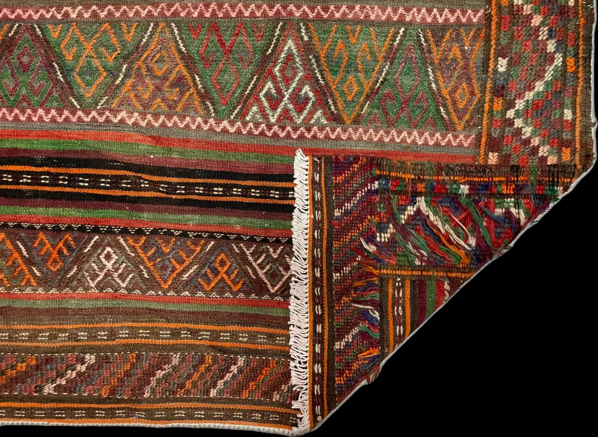 Persian rug of Sumak style in dimensions 155 centimeters length by 135 centimeters width with mainly green and brown colors — Folded