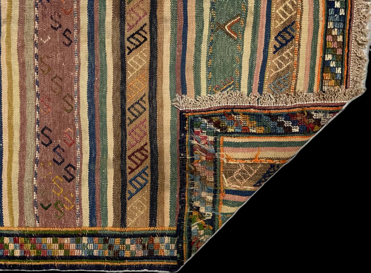 Persian rug of Sumak style in dimensions 128 centimeters length by 120 centimeters width with mainly green and yellow colors — Folded